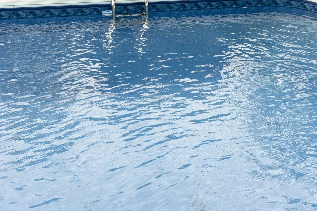 A clean backyard pool with clear blue water